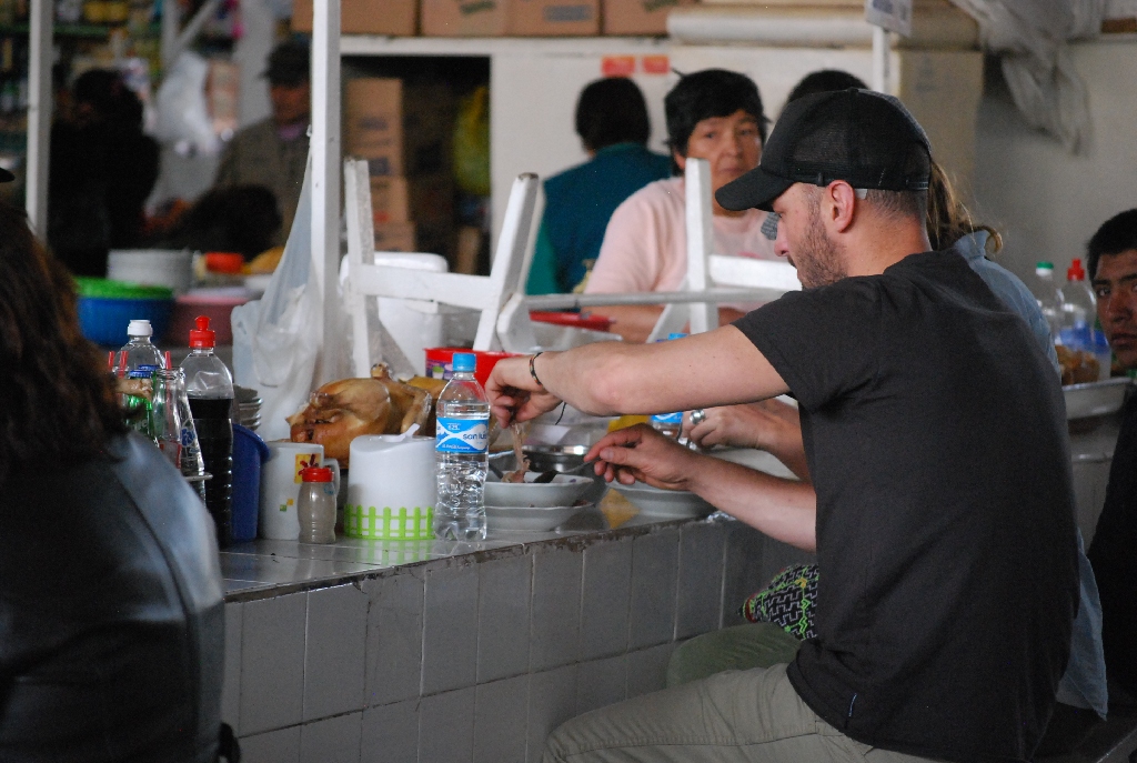 A tourist eating Chicken Soup in San Pedro Market