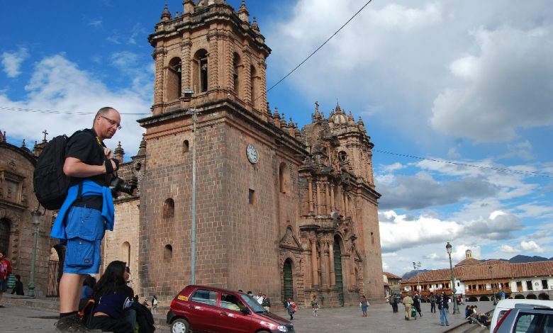 Cuzco's Cathedral with a Tourist by Its Side