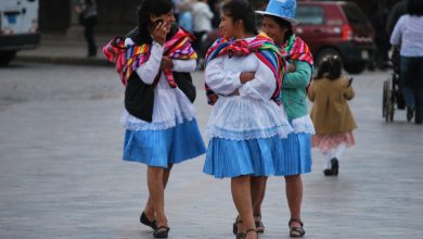 Beautiful Women with Colorful Dresses Walking Down the Plaza de Armas